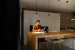 © Alba Vitta/Stocksy - Man paying utility bills from home calculating expenses