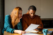 © Alba Vitta/Stocksy - Serious couple paying utility bills at home