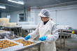 © Daniel Gonzalez/Stocksy - Hispanic woman working in workshop of canning factory
