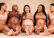 Pregnancy, body and laughing women sitting on studio background floor in relax support, mothers day or diversity. Happy smile, pregnant and bonding friends in underwear for with funny, comic or joke
