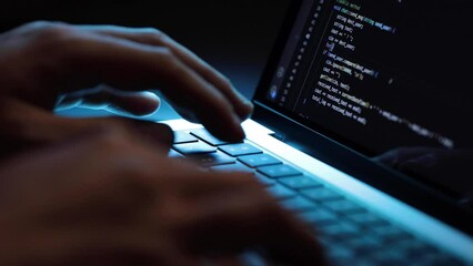 closeup of hands typing codes at late night