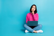 Full length photo of pretty doubtful lady wear pink pullover reading modern device empty space isolated blue color background