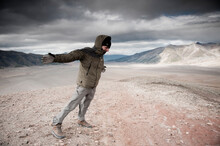 A Mountaineer  Leans Into A Strong Wind In The Valley Of Ten Thousand Smokes, Katmai National Park, Alaska.