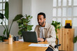 © Nuria Seguí/Stocksy - Ethnic Entrepreneur Man Using Laptop In Office