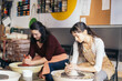 © Pedro Merino/Stocksy - Women working in a pottery workshop