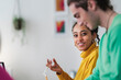 © Studio Marmellata/Stocksy - Smiling woman talking with colleague in office