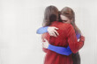 © Renata Garipova/Stocksy - Two persons hugging each other against white background