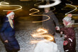 © Evgenij Yulkin/Stocksy - Woman and children light sparklers