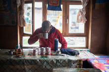 Man Drinking Tea In Village Town In Himalayan Mountains
