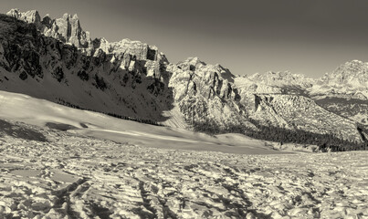 Wall Mural - Mountain peak and snowy valley in winter season against a beautiful sunny blue sky