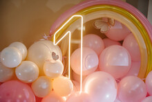 Birthday Party For 1 Year Old Girl On A Background Photo Wall. Arch Decorated Pink Balloons, Neon Number One, Rainbow, Paper Decor Butterfly. Children's Photo Zone. Closeup Decor.