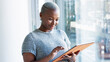 © Nina/peopleimages.com - Business woman and office research on tablet for positive insight with wireless wifi gadget. Satisfied black person in corporate career typing important data on digital device with internet.