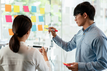 Aufkleber - Two business executive team holding and taking notes keyword on board wall to brainstorm about a new business project for planning marketing plan together in the office