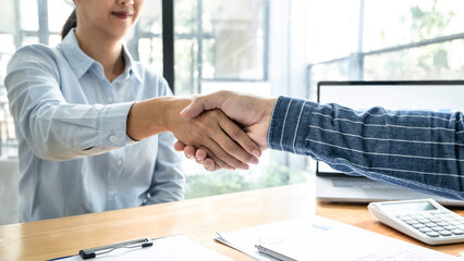 Poster - Two business people shaking hands after discussing a good deal of contract agreement and new projects for both