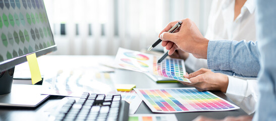 Poster - Team of creative graphic designer working on color swatch samples chart for selection coloring in inspiration to create new collection at workplace