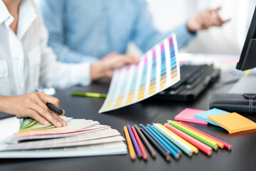 Poster - Team of creative graphic designer working on color swatch samples chart for selection coloring in inspiration to create new collection at workplace