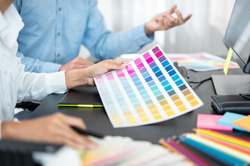 Poster - Two creative graphic designer team working on color selection and drawing on graphic tablet, Color swatch samples chart for selection coloring in inspiration to creativity at workplace