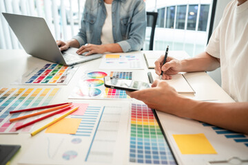 Poster - Two creative graphic designer team working on color selection and drawing on graphic tablet, Color swatch samples chart for selection coloring in inspiration to creativity at workplace