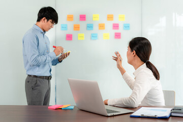 Aufkleber - Two business executive team holding and taking notes keyword on board wall to brainstorm about a new business project for planning marketing plan together in the office