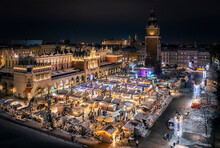 Christmas Stalls With Snow At Night On The Main Market Square In Krakow, Poland