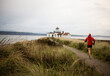 © Cavan Images - A runner follows a trail along the Puget Sound at Discovery Park, Seattle, WA.