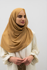 Wall Mural - Portrait of young muslim woman wearing hijab on isolated white background