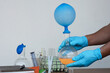Student do science experiment, lab lesson, transparent bottles with inflated balloons on top of bottle. The experiment about air or gas reaction by using chemical substances. Education Science subject