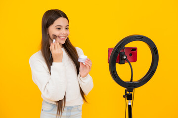 Poster - Child recording video tutorial for social media with smart phone. Influencer teenager creating new content for blog while streaming online. Beauty blog, presenting makeup cosmetics powder and brush.