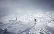 © jenyateua - Stunning winter nature landscape. Alone man in snow covered mountain. Hiker, photographer on the snowcapped highland. Outdoors active lifestyle concept. Snowy mountain scenery with cloudy day