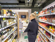 © lado2016 - Woman choosing frozen food from a supermarket freezer.choosing a dairy products at supermarket.