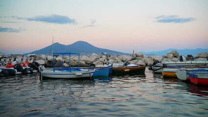 Wall Mural - Naples, Italy - 12.06.2022: Fishing boats and Vesuvius mountain.