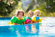 © famveldman - Kids in swimming pool. Life jacket for child.
