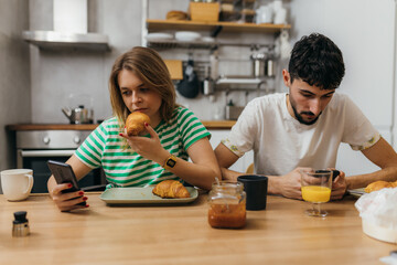 Wall Mural - Young couple eats breakfast in silence