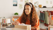 © Nina/peopleimages.com - Delivery, online order and woman in fashion on laptop while working at a boutique. Young, happy and African designer shipping stock of clothes in boxes and pc for service at a small business