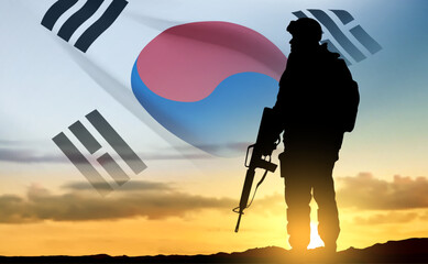 Silhouette of a soldier on background of sunrise and flag of South Korea. Armed forces of South Korea concept. EPS10 vector