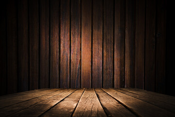 image of a wooden table on an abstract dark background with light in the center