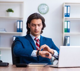 Young male businessman working in the office