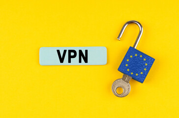 Poster - On the yellow surface is an open lock with a key and a sticker with the inscription - VPN