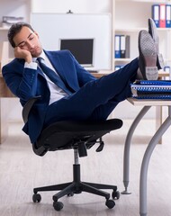 Young male businessman working in the office