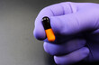 © TopMicrobialStock - Doctor's hand with a capsule, antibiotic, or medicine pill