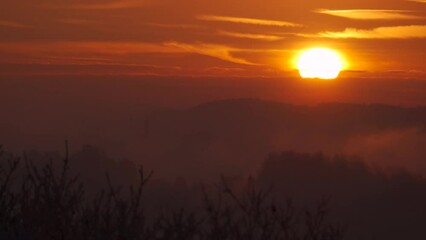 Wall Mural - Sunrise background over layers of countryside cloud