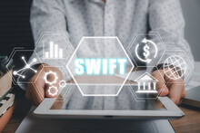 SWIFT, Society For Worldwide Interbank Financial Telecommunications, Business Person Using Tablet With VR Screen Swift Icon On Office Desk, Financial Banking Regulation Concept.