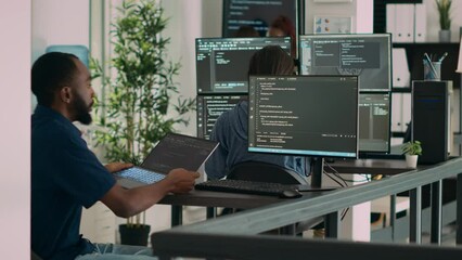 Database programer working on html script code to develop program app server with new use rinterface. Web developer typing on keyboard, computing big data on terminal window in office.