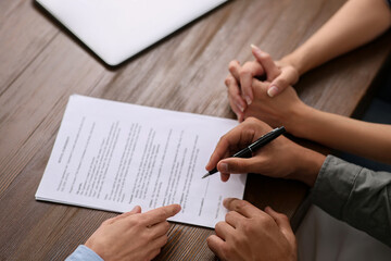 Sticker - Notary helping couple with paperwork at wooden table, closeup