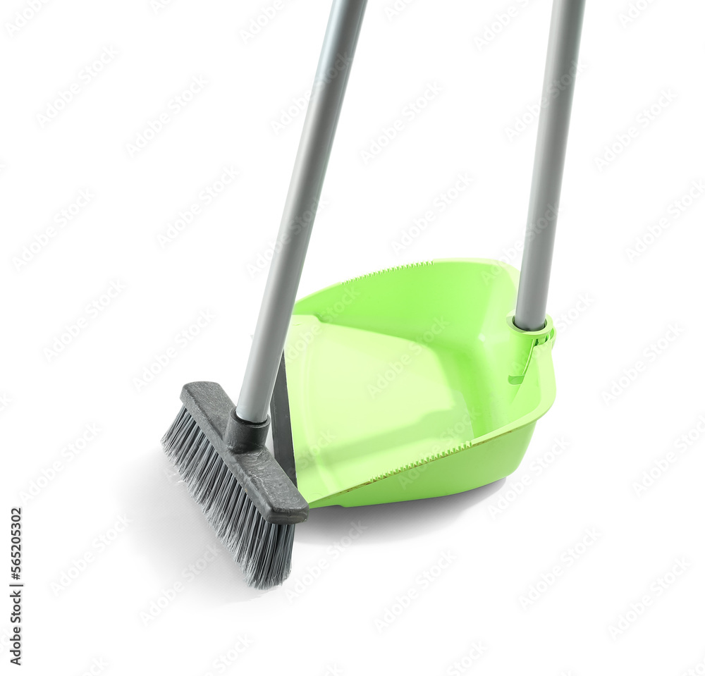 Cleaning broom with green dustpan on white background