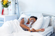 © WavebreakMediaMicro - African american boy patient on ventilator asleep in hospital bed with copy space