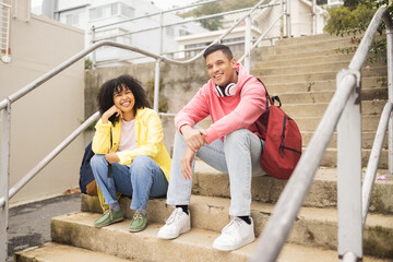 Wall Mural - Portrait, stairs and students with a man and black woman sitting outdoor on campus together at university for education. Scholarship, college and school with a male and female pupil seated on steps