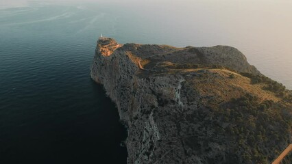 Wall Mural - Drone point of view to The Formentor Lighthouse on rocky mountains top surrounded by waters of Mediterranean Seascape. Balearic Islands. Spain