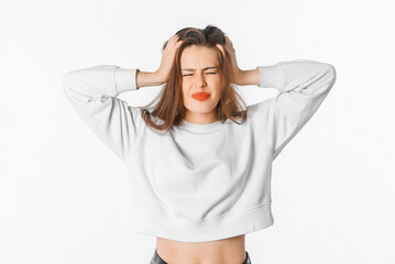 Wall Mural - Image of shocked anxious woman in panic, grabbing her head and worrying, standing frustrated and scared against white background. Stress concept