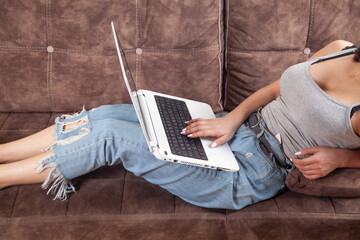 Wall Mural - Woman using white laptop computer at home.